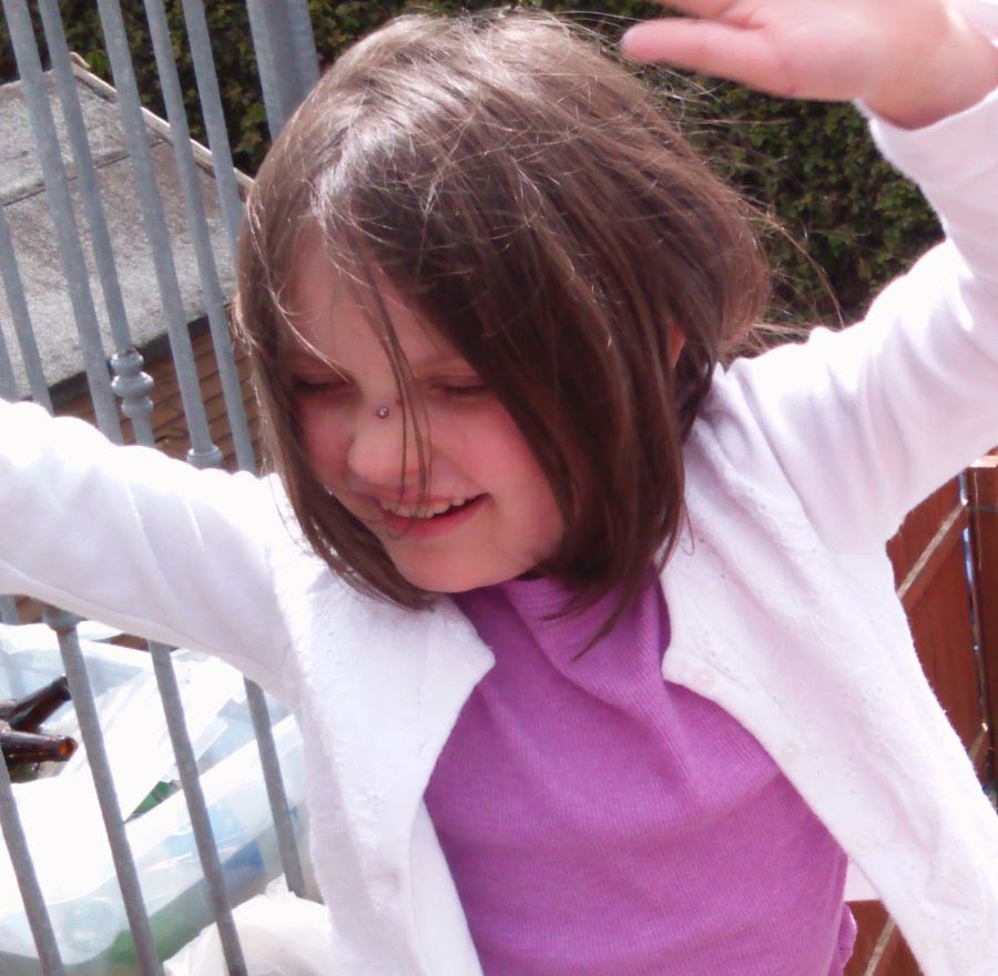 Young Ella dancing in the garden